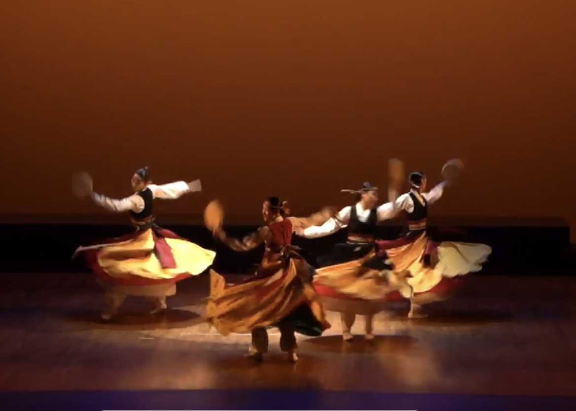 Traditional dance in warm stage light